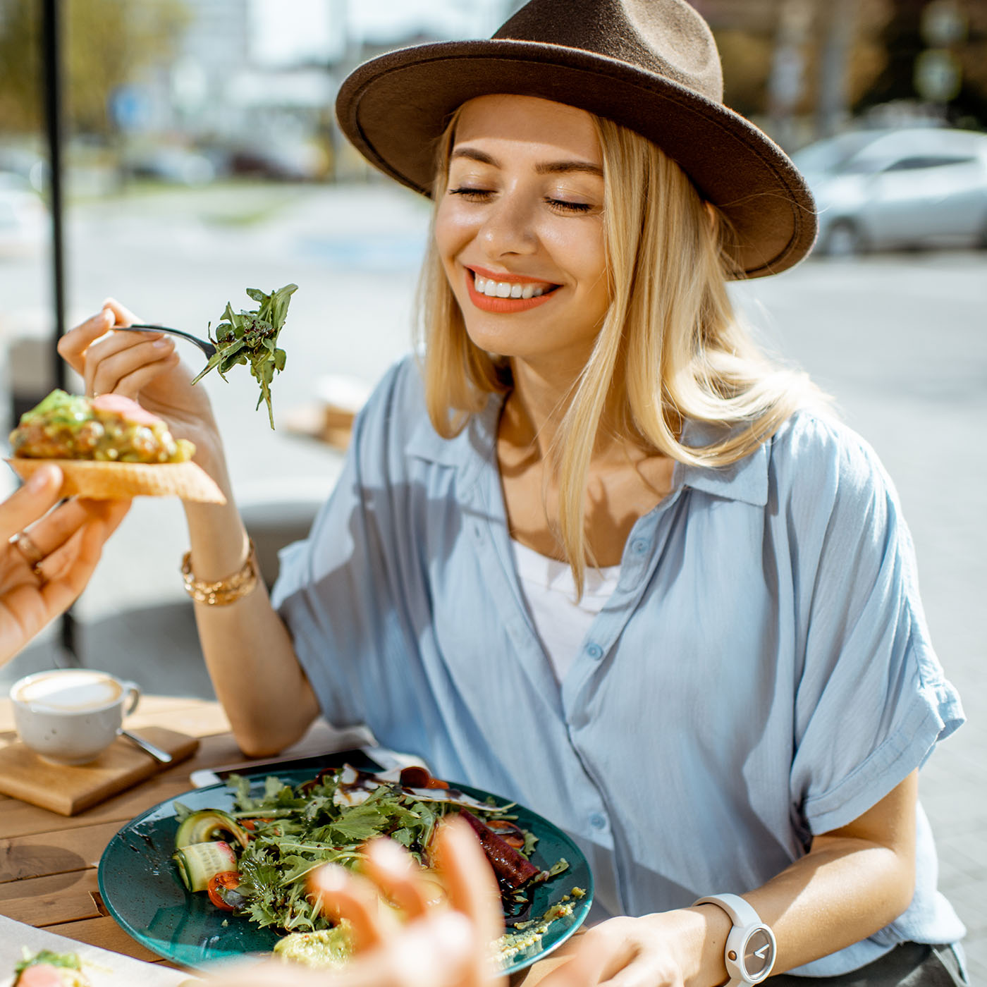 girlfriends-eating-healthy-food-on-a-terrace-2022-01-18-23-53-55-utc